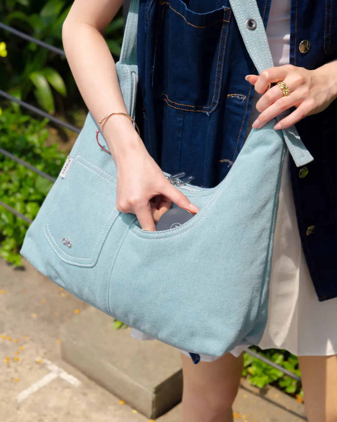 SIGNATURE POCKET HOBO BAG IN LIGHT WASH DENIM TSL Singapore